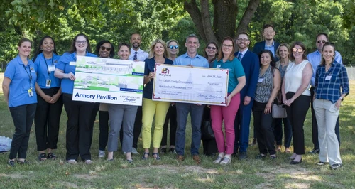 A group of people holding a giant check.