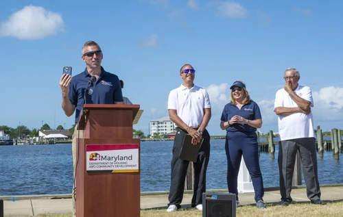 A man talking outside at a podium.
