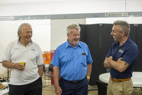 Three men talking and laughing.