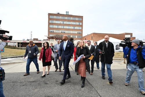 A group of people walking with cameras.