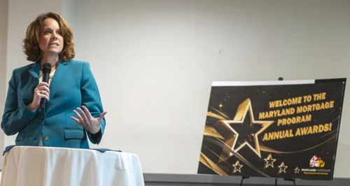 A woman speaking into a microphone.