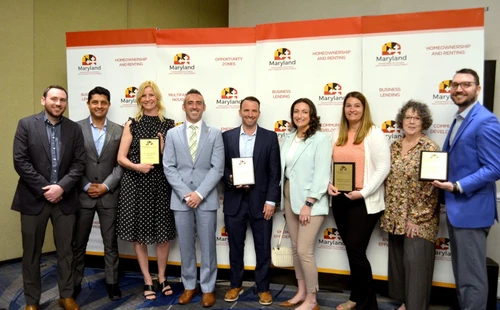 A group of people posing with awards.