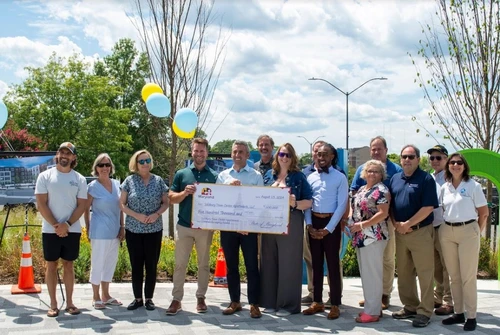 A group of people holding a giant check.