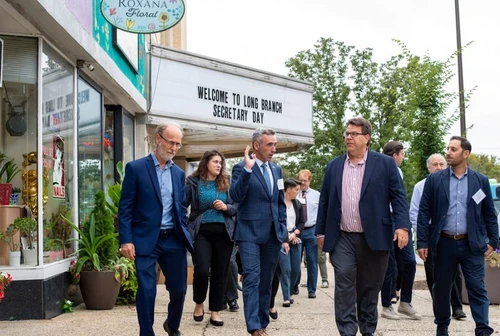 A group of people in business suits walking outside.