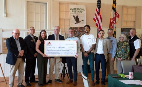 A group of people holding a giant check.