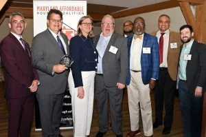 A group of people in business clothes pose for a picture.