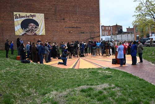 A crowd attending a speaking from a man at a podium.