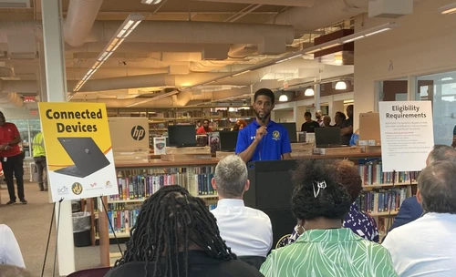 Brandon Scott speaking to people sitting down.
