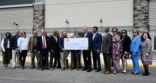 A group of people holding a giant check.