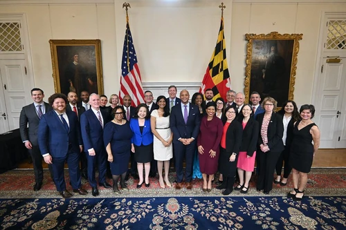 A group of people posing in a government building.