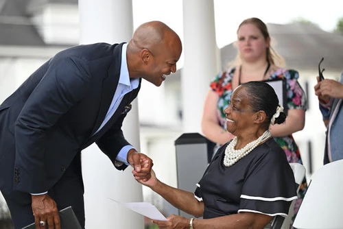 A man talks to a woman.