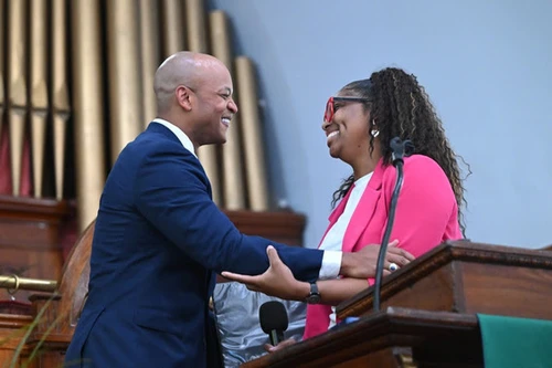 A man and a woman smile at each other.