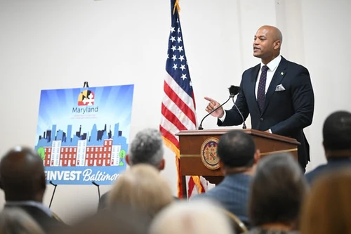 A man speaks at a podium.