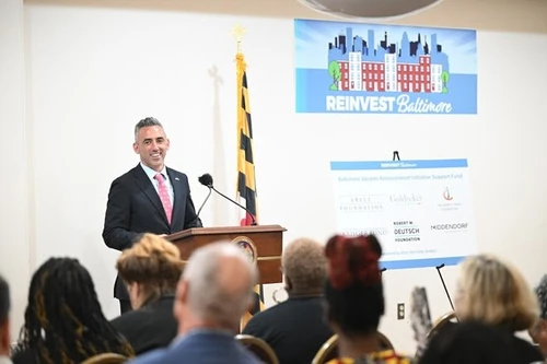 A man speaks at a podium.