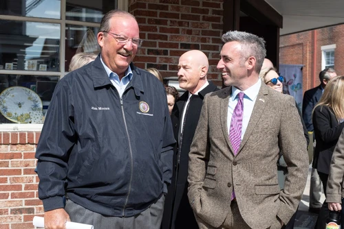 Two men talking a smiling.