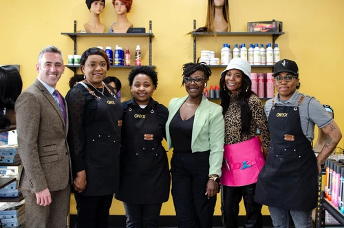 A group of people posing in a salon.
