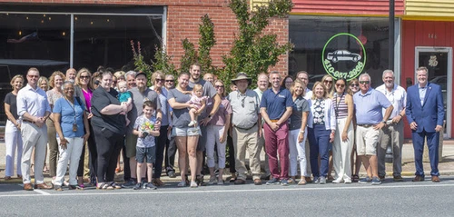 A group of people posing in front of a building.