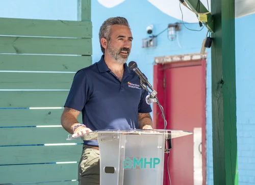 Secretary Day speaks at a podium in Long Branch.
