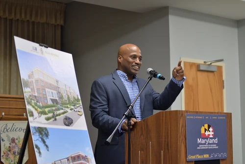 Malik Jordan, Woda Cooper Companies, speaks at a podium