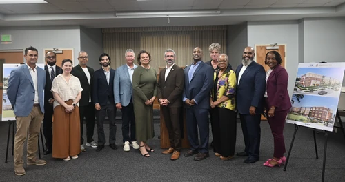 Secretary Day and other event speakers pose for a photo with awarded developers.