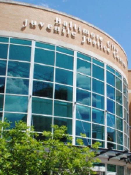 Multi-story glass entrance of the Baltimore City Juvenile Justice Center, a multi-purpose juvenile justice building.