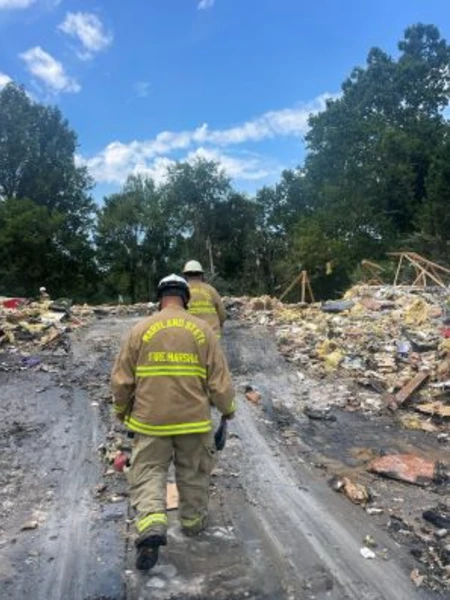Two Maryland State Fire Marshals walking in the remains of a fire