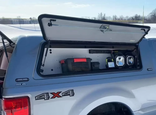Open cab-mounted toolbox on a fire marshal vehicle showing evidence collection supplies.