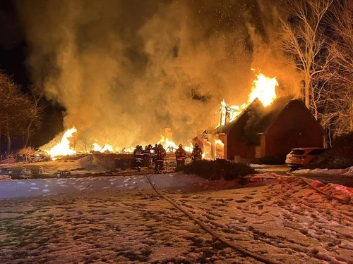 A home engulfed in flames during an active fire emergency