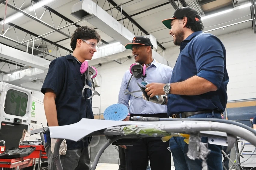 Governor Moore with the owner of Fox Automotive and a high school student