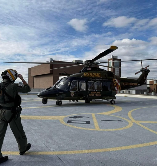 A Maryland State Police medevac helicopter and medevac pilot approaching the helicopter