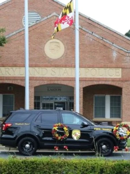 Maryland State Police Easton Barrack with a State Trooper cruiser in front of the building