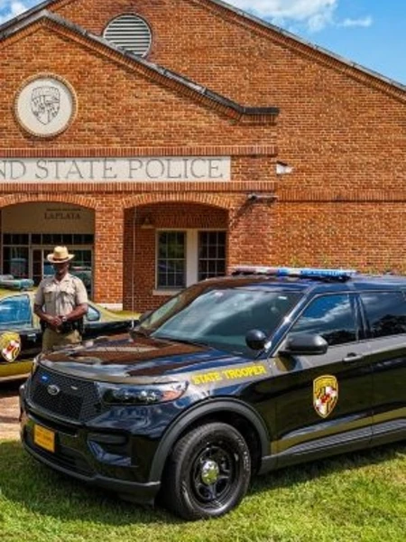 La Plata Barrack with a state trooper and his cruiser in the front of the barrack.