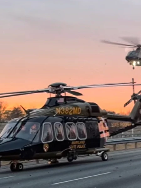 Two Maryland State Police helicopters with one on the ground and other in the air