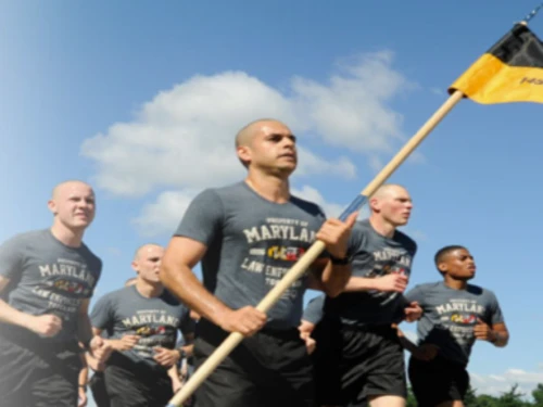Maryland State Trooper cadets running with a Maryland State flag