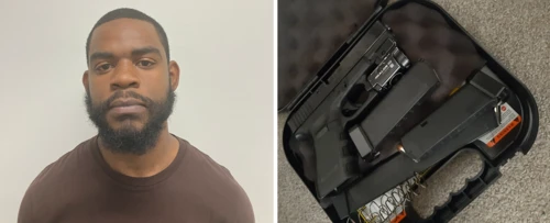 A man with a beard in a brown shirt stands against a white background on the left. On the right, a gun and magazine clips are in an open black case on gray carpet.