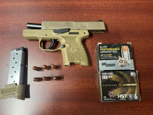 A tan handgun with ammo.