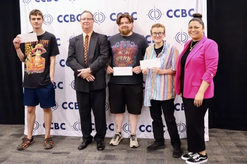 A group of students at CCBC posing after winning the PSA contest for the Maryland Vehicle Theft Prevention Council