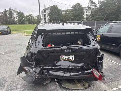 a rear marked maryland state police patrol vehicle with damage. 