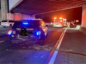A Maryland State Trooper car with a crashed in back