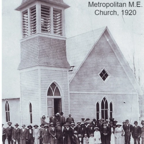 ground of black men and women standing in front of a church