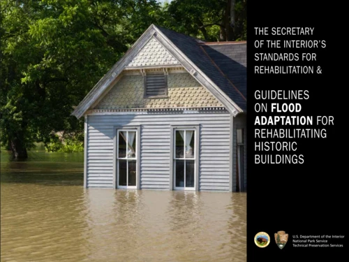 The cover page of a National Park Service publication titled 'Guidelines on Flood Adaptation for Rehabilitating Historic Buildings,' featuring a photograph of a historic grey wooden house partially submerged in brown floodwater.