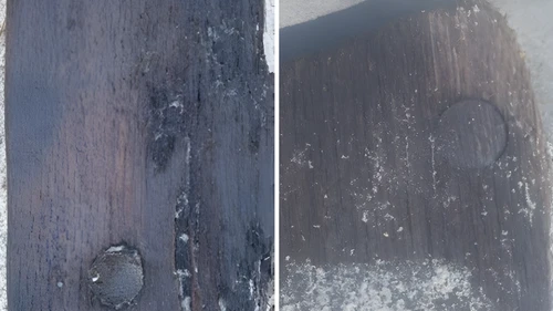 Close-up of two weathered wooden surfaces with sand and treenails.
