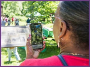 Woman taking a picture on a handheld phone.