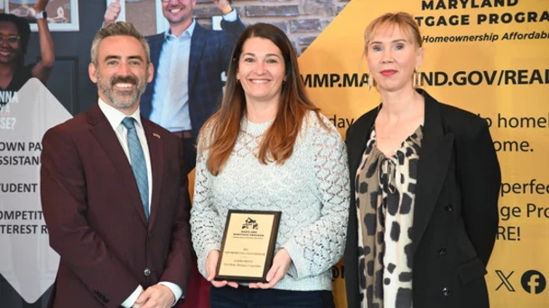 DHCD Secretary Jake Day and Director of Homeownership Programs Maddy Ciulu present an award at the 2026 MMP Annual Awards