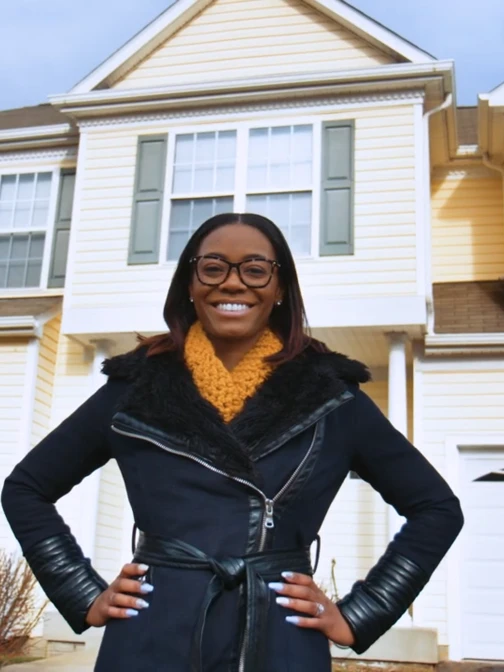 Jessica Smith standing in front of her new home
