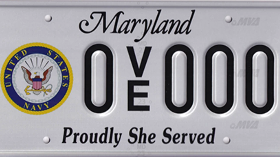 White license plate with the Navy seal to the left of the plate number.
