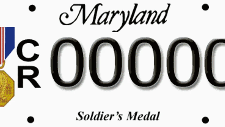 White license plate with the Soldier's Medal to the left of the plate number.