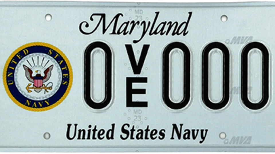 Light blue plate with the Navy seal to the left of the plate number.