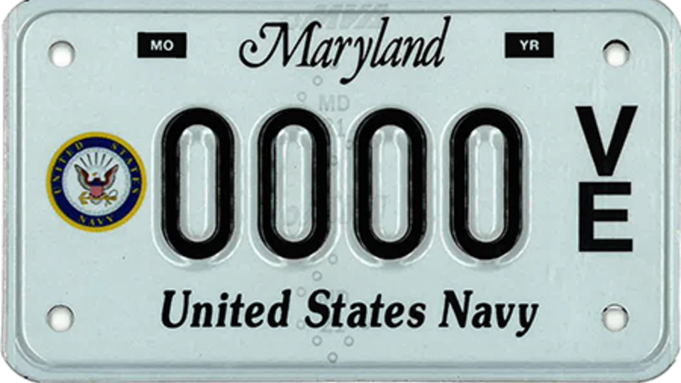 Light blue plate with the Navy seal to the left of the plate number.