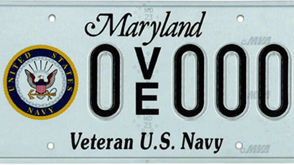 Light blue plate with the Navy seal to the left of the plate number.
